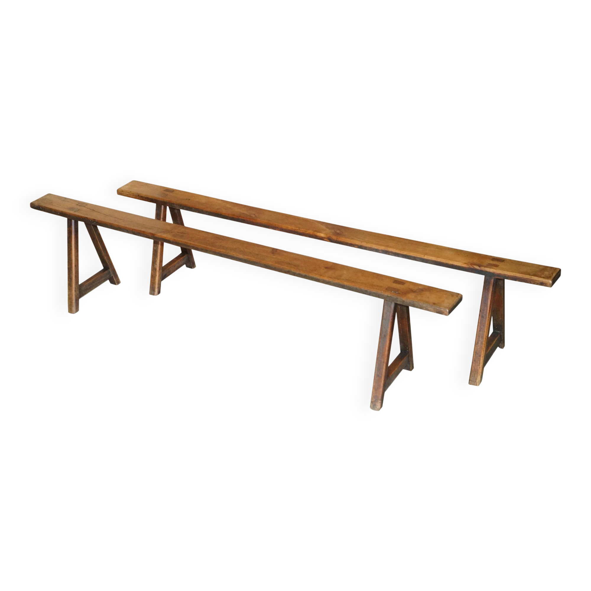 Pair of antique Victorian trestle benches in fruitwood.