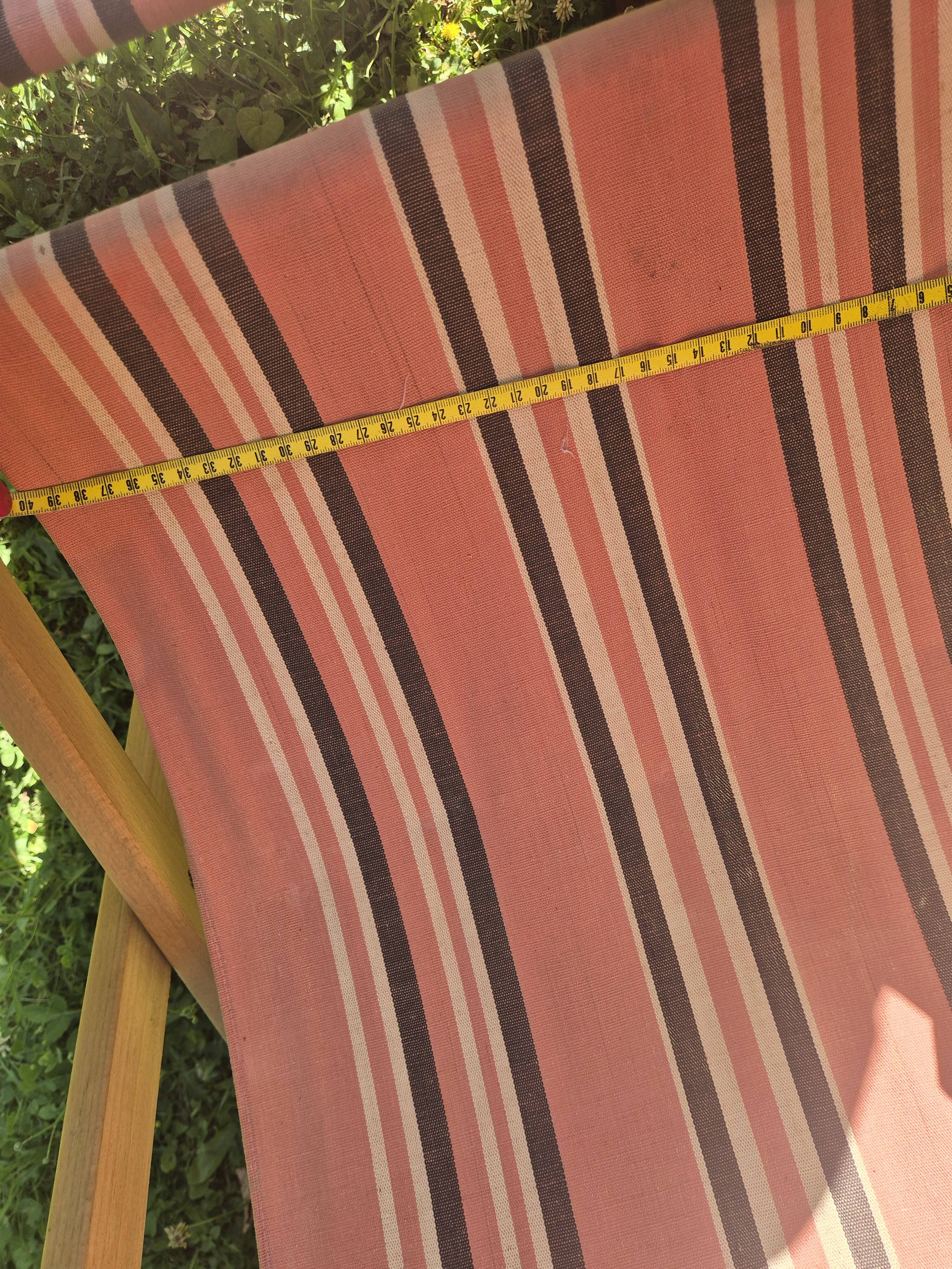 vintage wooden deck chair with striped fabric and footrest