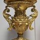 Rare pair of carved and gilded wooden vases, with a refined style inspired by the Empire.