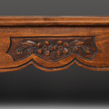 Side table with sculpted elements and rattan top