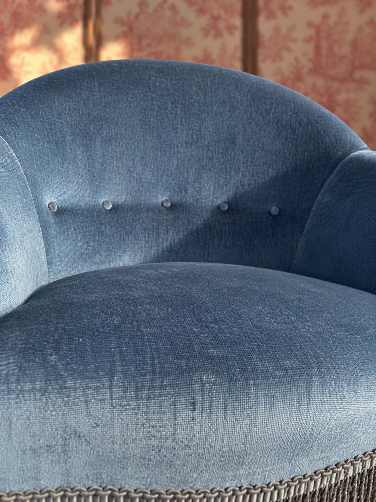 Vintage blue velvet frog chair, a timeless comfortable piece.