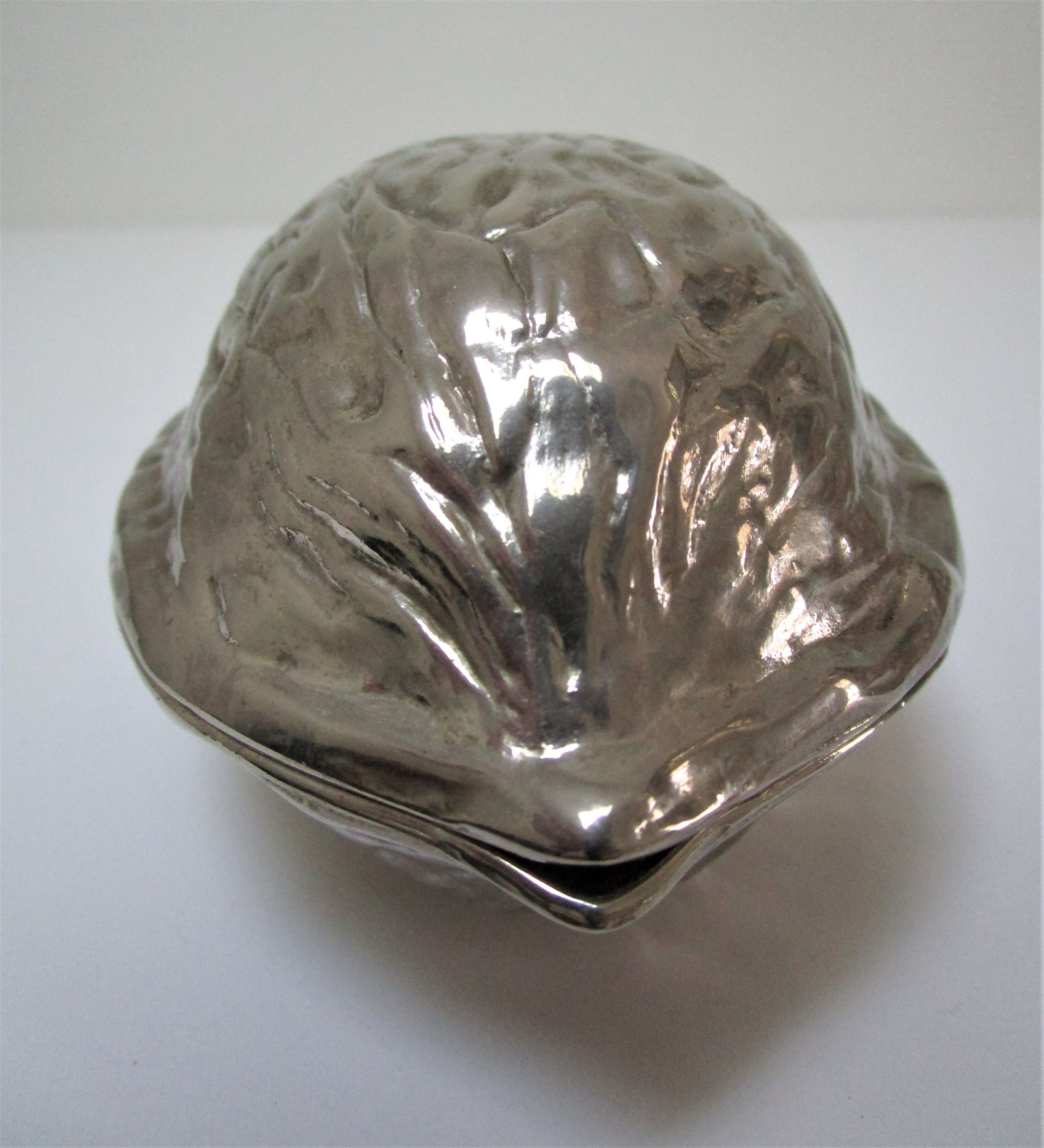 silver metal nutcracker in the shape of vintage walnuts