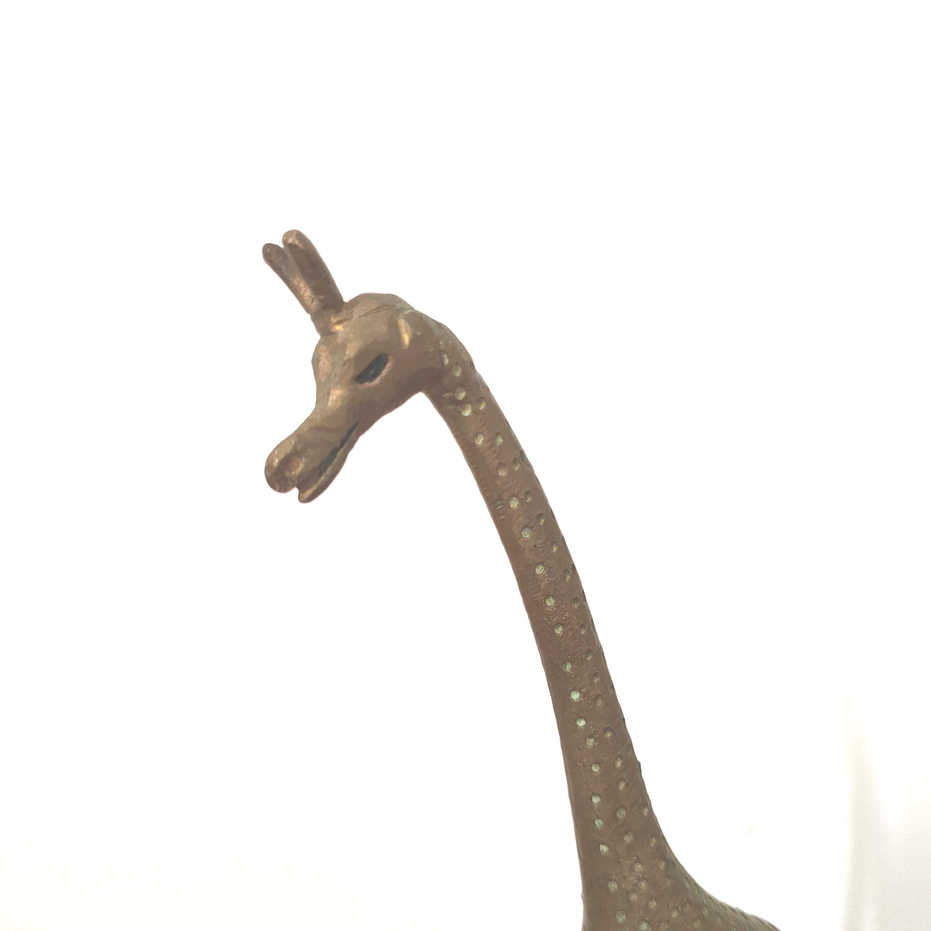 Giraffe and brass bird