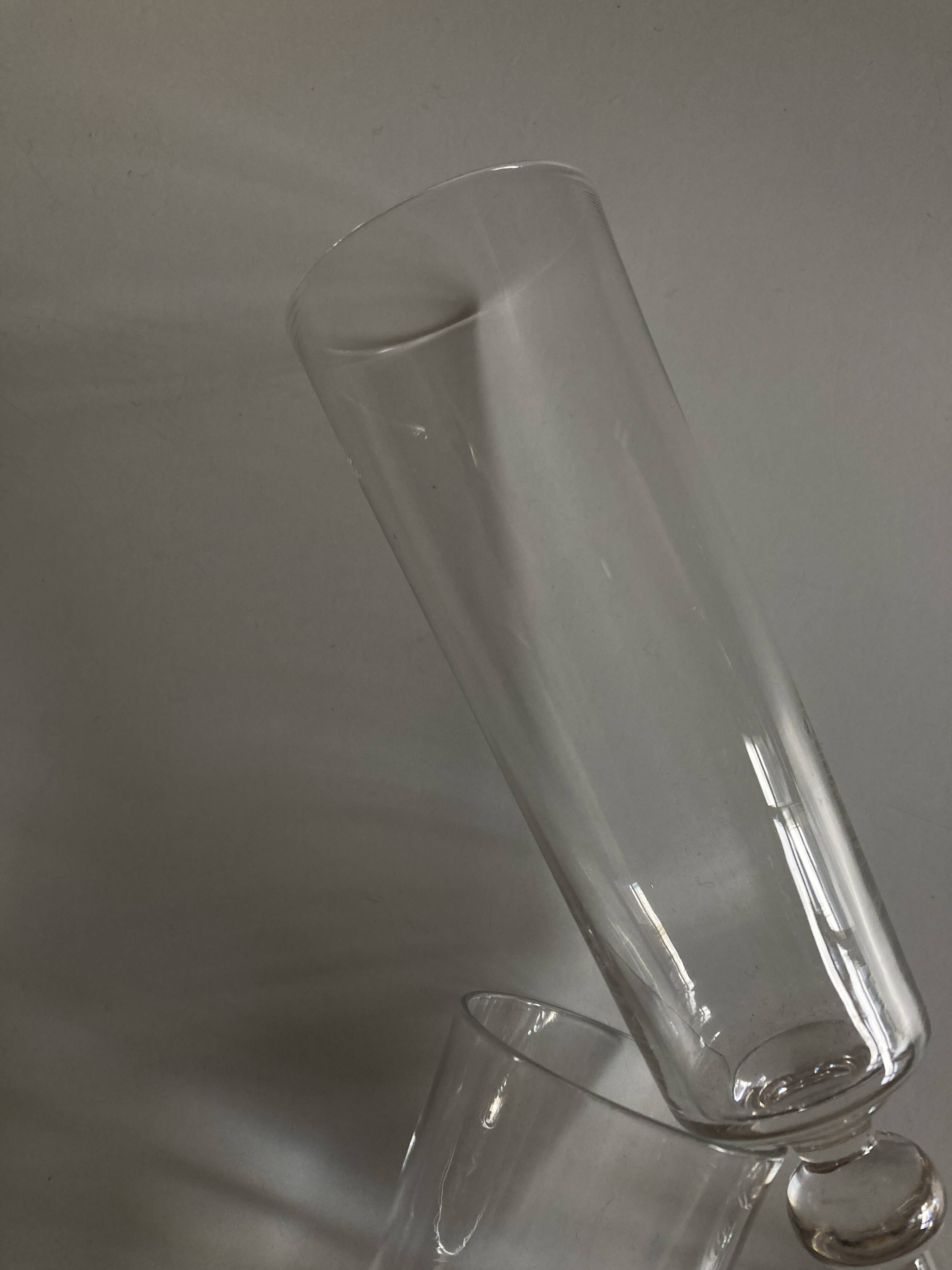 Pair of crystal champagne flutes with a button foot, 1960.