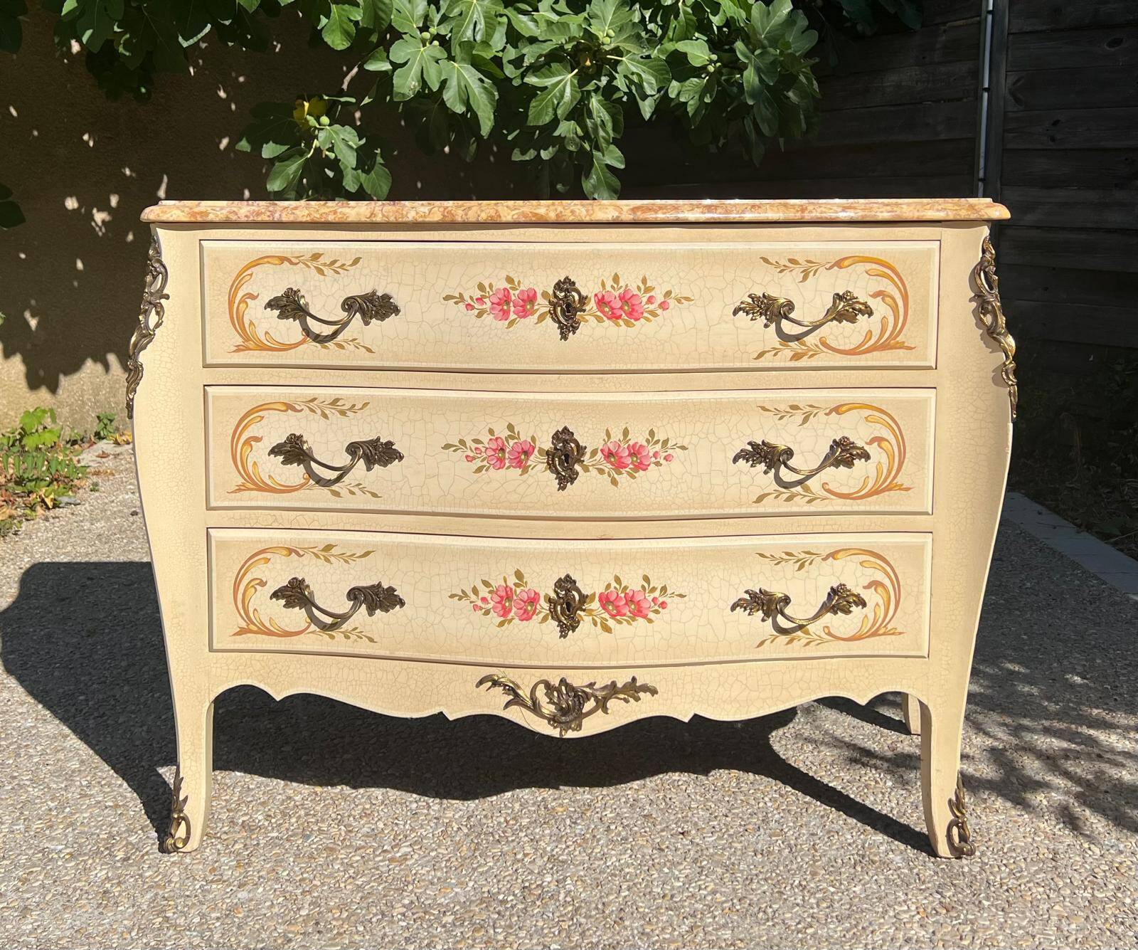 Curved Louis XV style commode in marble with painted floral decoration.