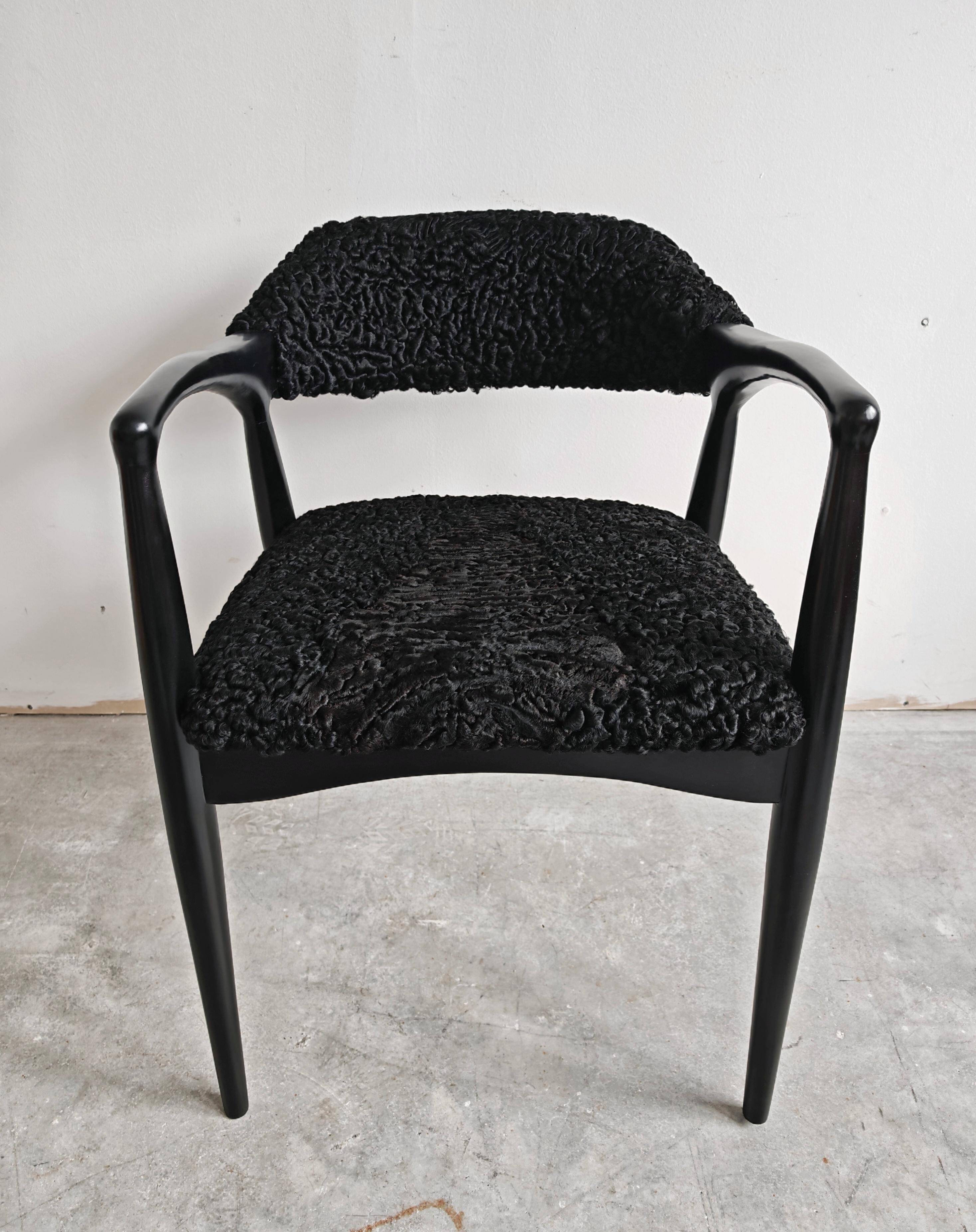 Pair of Mid Century Modern armchairs in astrakhan leather.