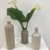 Trio of old sandstone bottles and jars