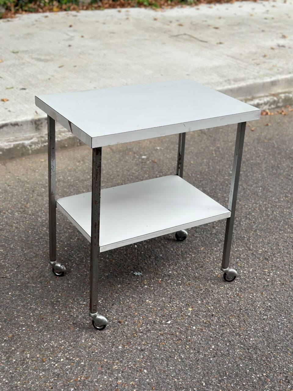 Rolling dessert trolley with 2 white formica shelves and steel, 1980.