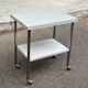 Rolling dessert trolley with 2 white formica shelves and steel, 1980.