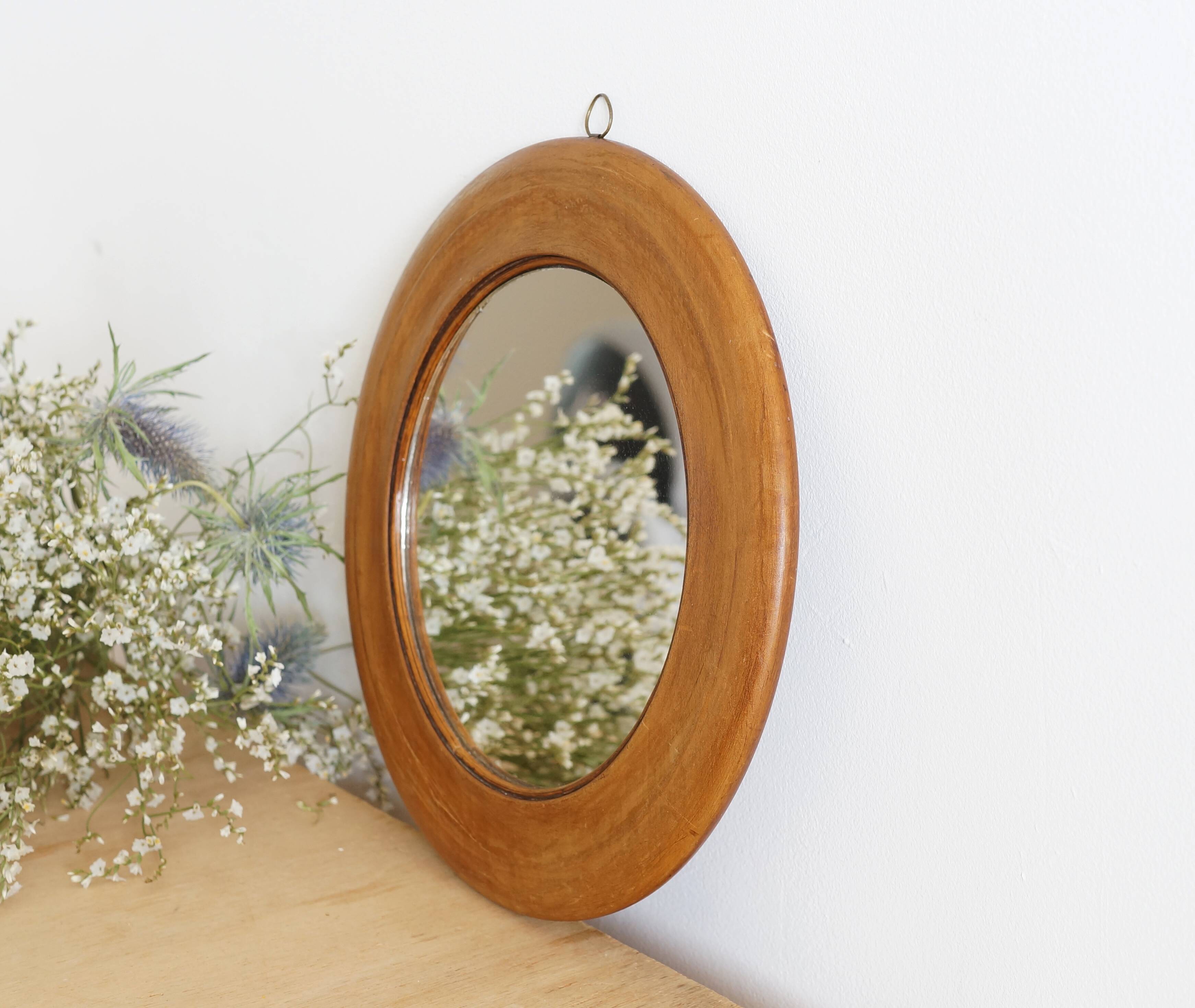 Antique round mirror with turned wooden frame
