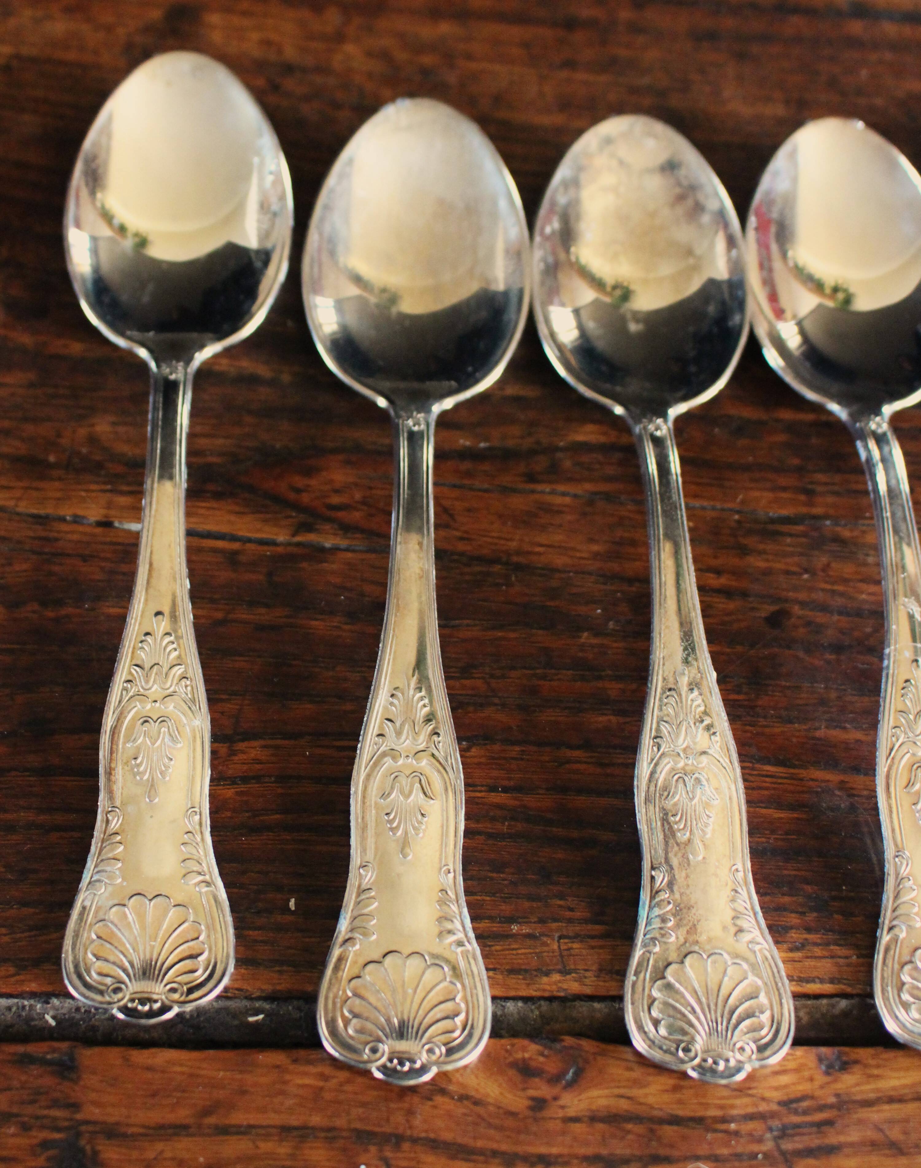 A set of 7 large metal shell spoons