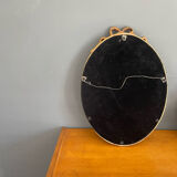 Golden oval mirror with knot