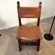 Spanish chair in leather and carved wood, 1950s/60s.
