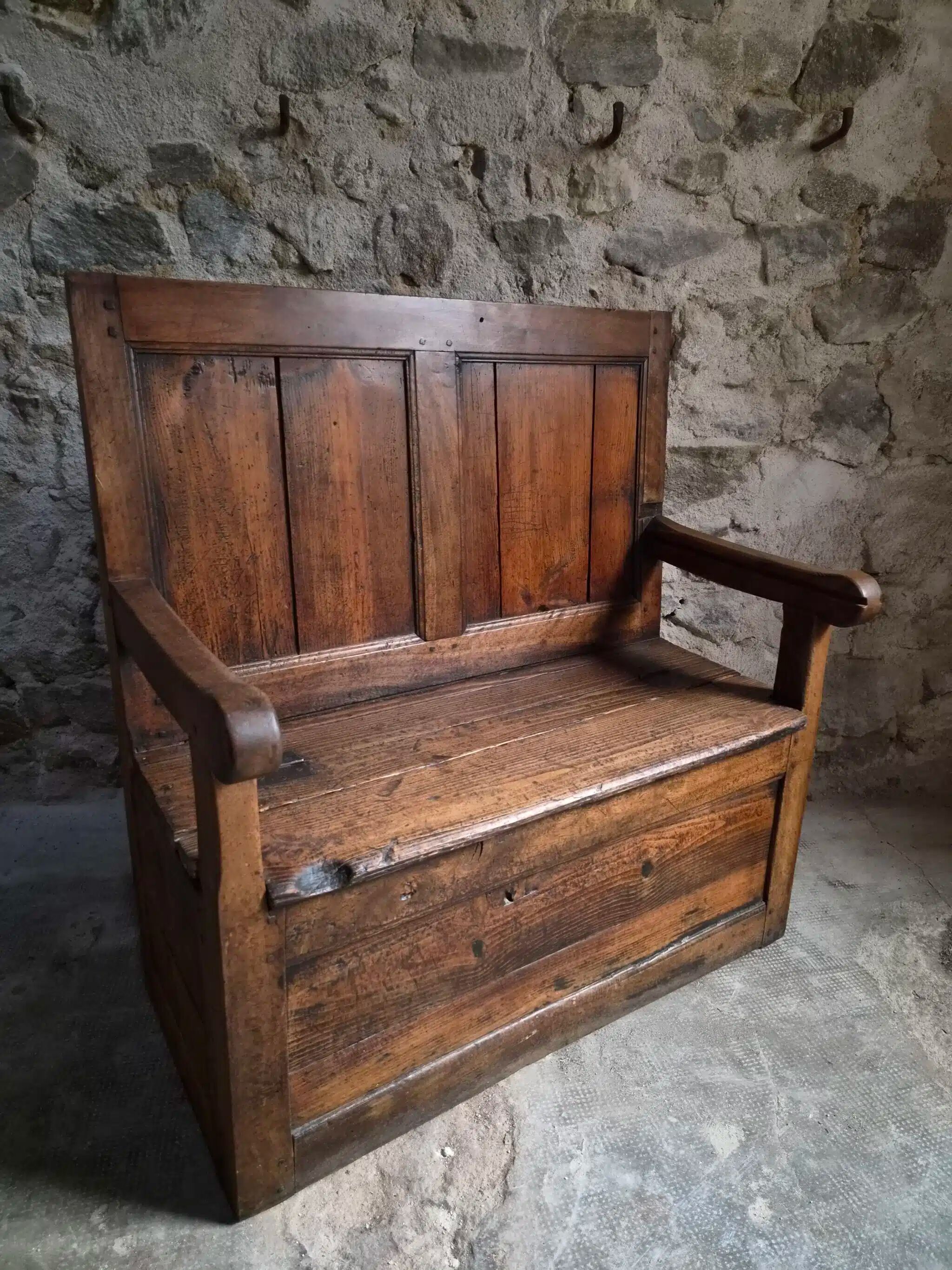 Rustic French antique storage bench from the 18th century in walnut and pine.