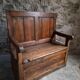 Rustic French antique storage bench from the 18th century in walnut and pine.