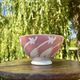 Old footed bowl in earthenware with pink decoration and defects.