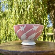 Old footed bowl in earthenware with pink decoration and defects.