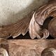 Wall-mounted coat rack on a carved wooden pediment