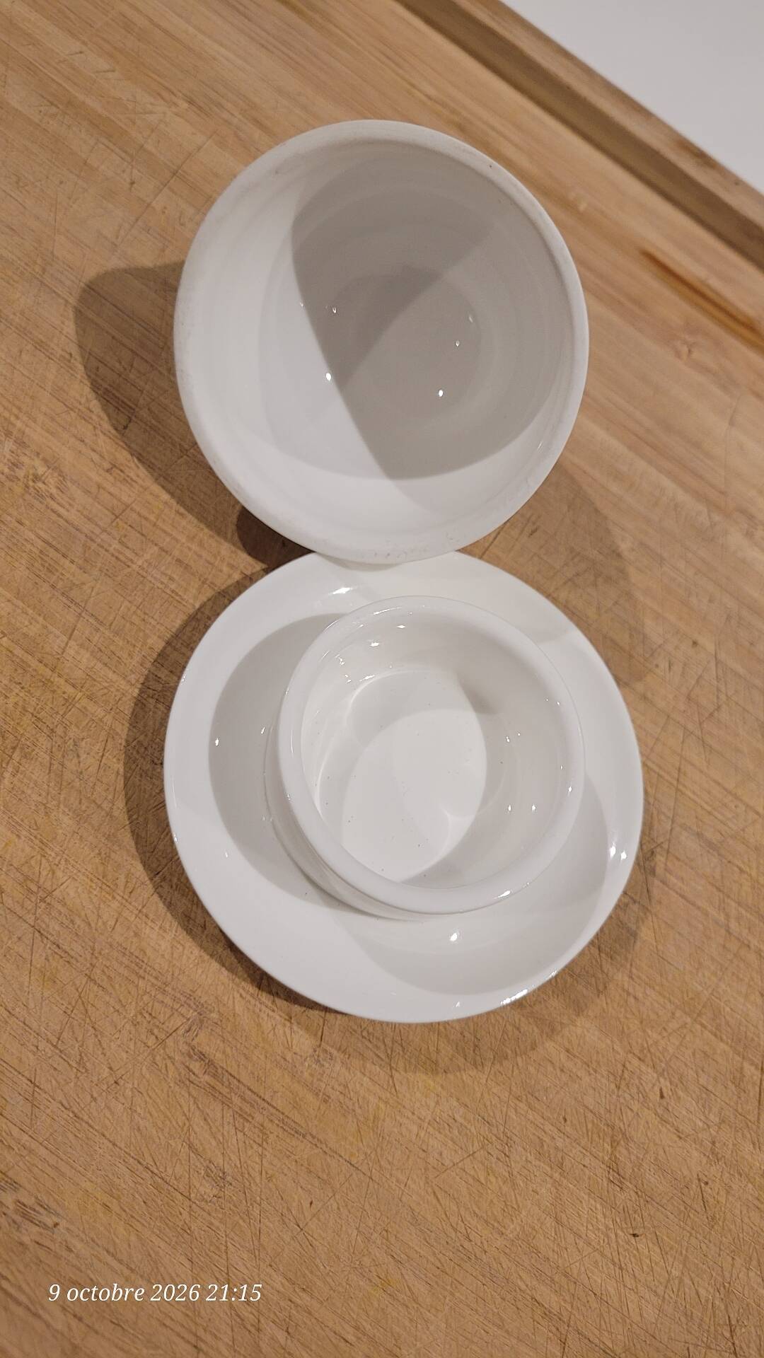 White porcelain butter dish accompanied by its matching bell.