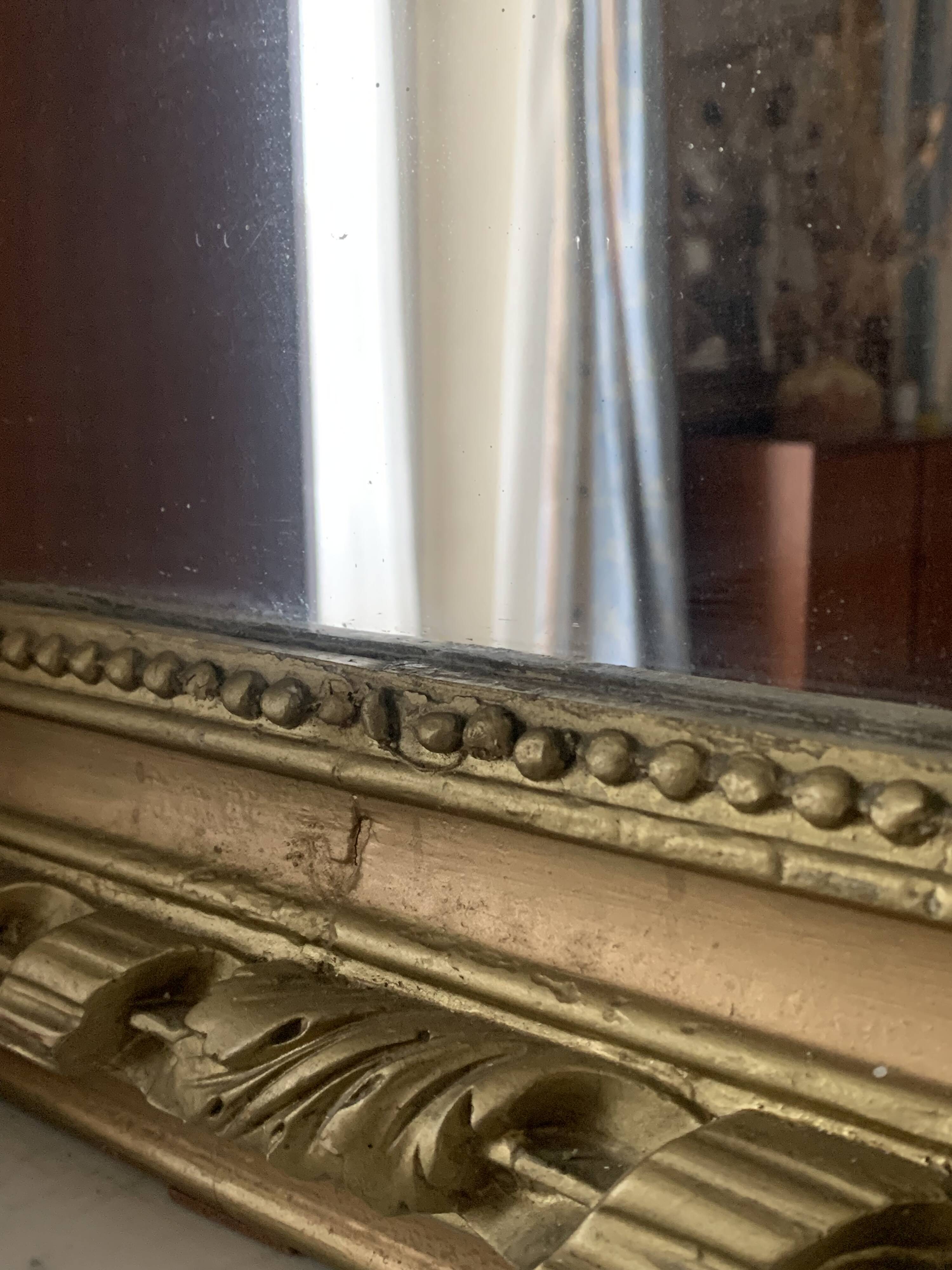 Gilded wooden fireplace mirror with pediment