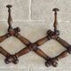 Wall-mounted accordion coat rack made of turned wood