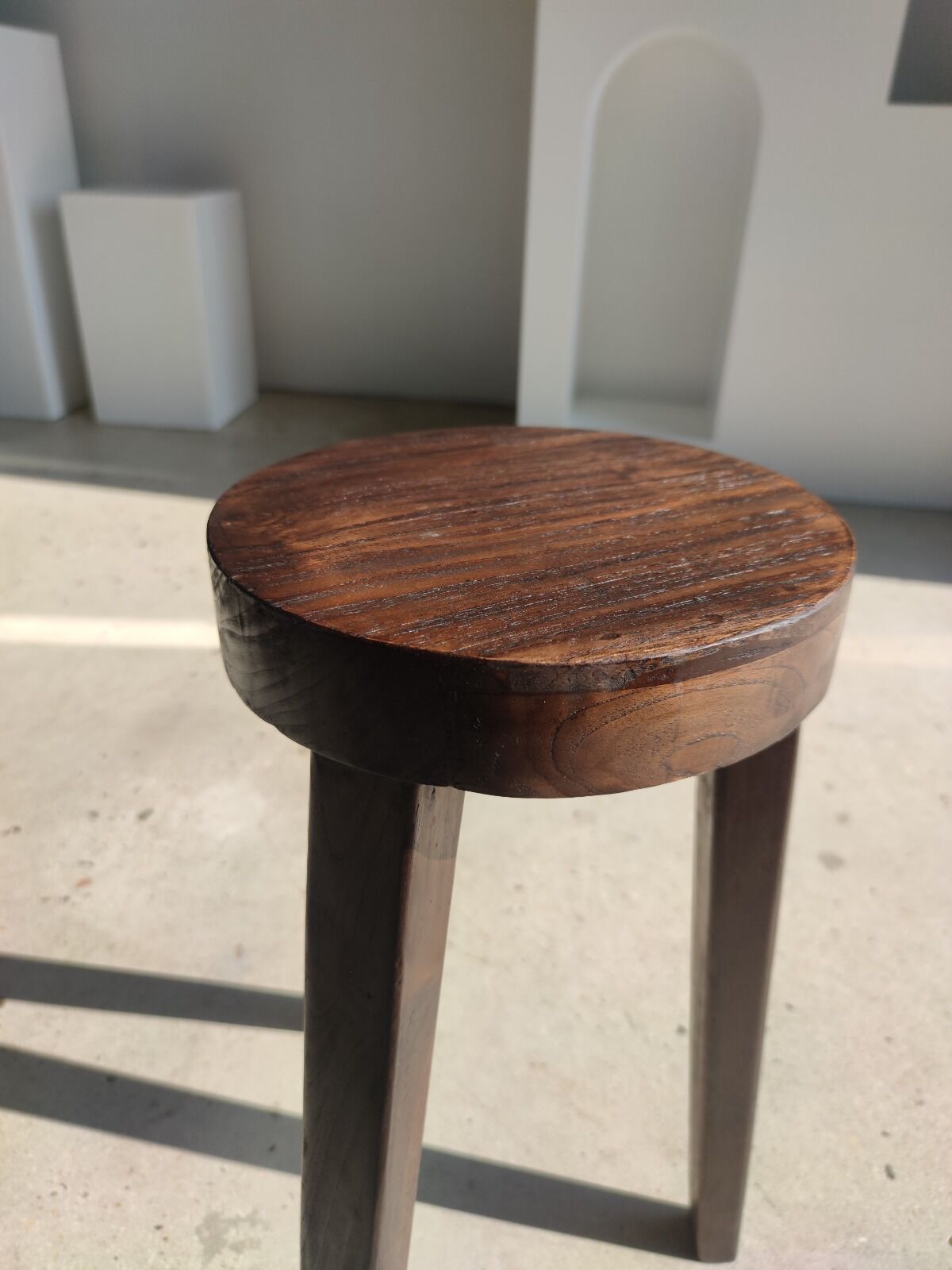 Small high tripod stool in brown solid wood
