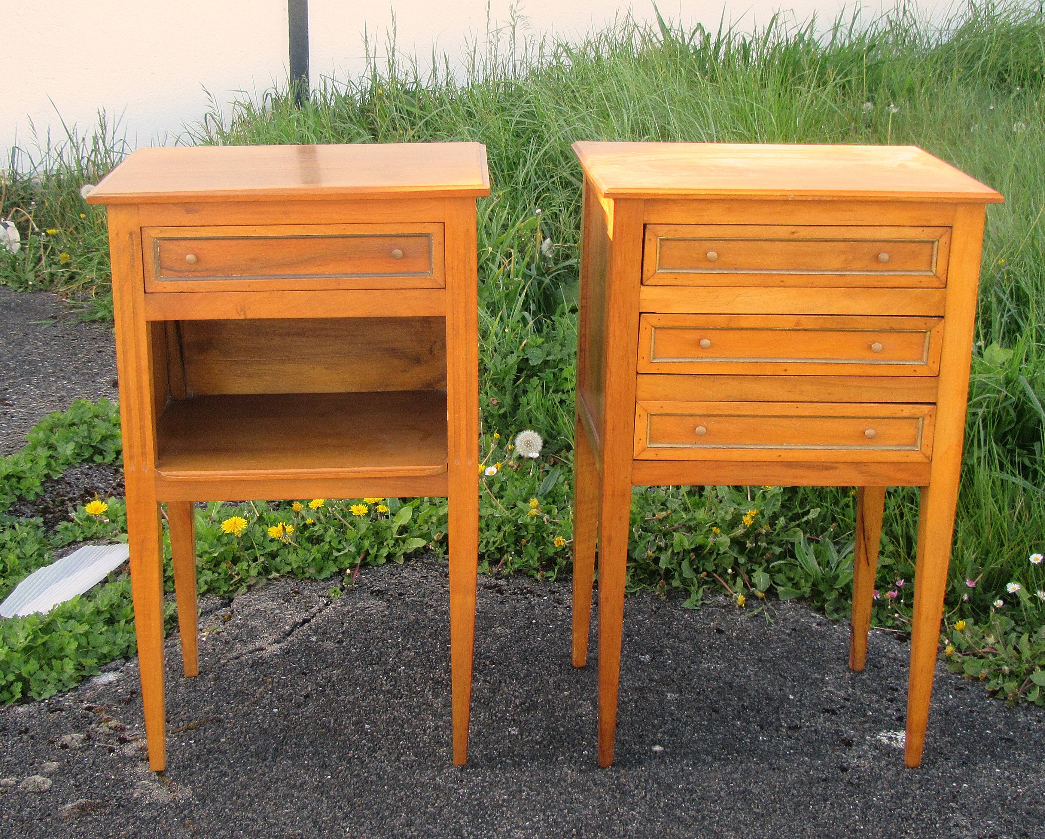 Pair of walnut bedside tables in Louis XVI style with brass inlay.
