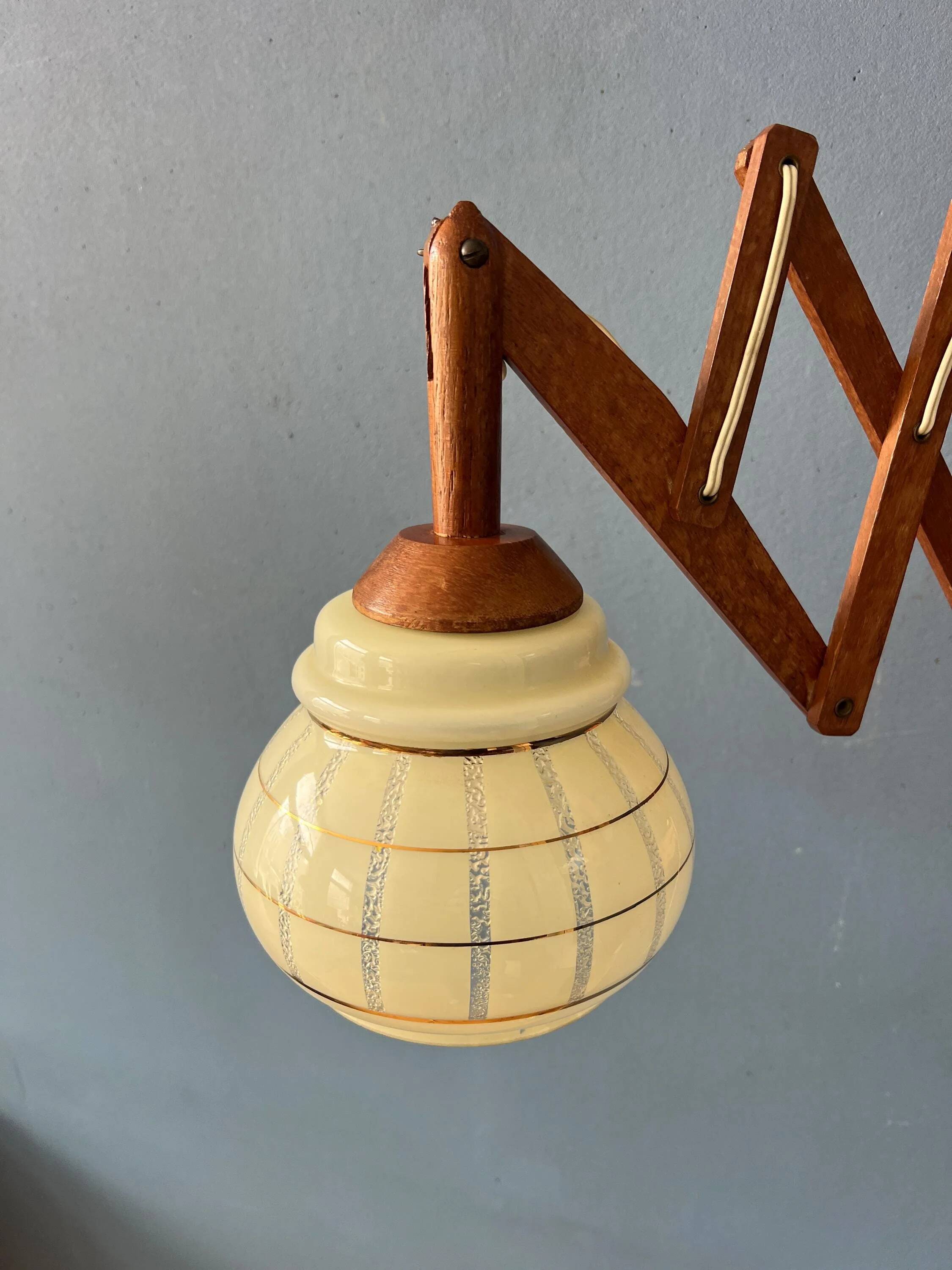 Vintage wall lamp with teak wood scissors and glass shade.