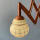 Vintage wall lamp with teak wood scissors and glass shade.