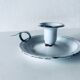 Old candle holder in white enameled metal