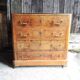 Old wooden chest of drawers with 4 drawers on wheels