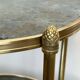 Round bronze side table with triple shelves of églomisé mirrors from Maison Baguès