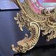 Beveled mirror in gilt bronze