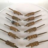 12 vintage bronze knife rests