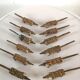 12 vintage bronze knife rests