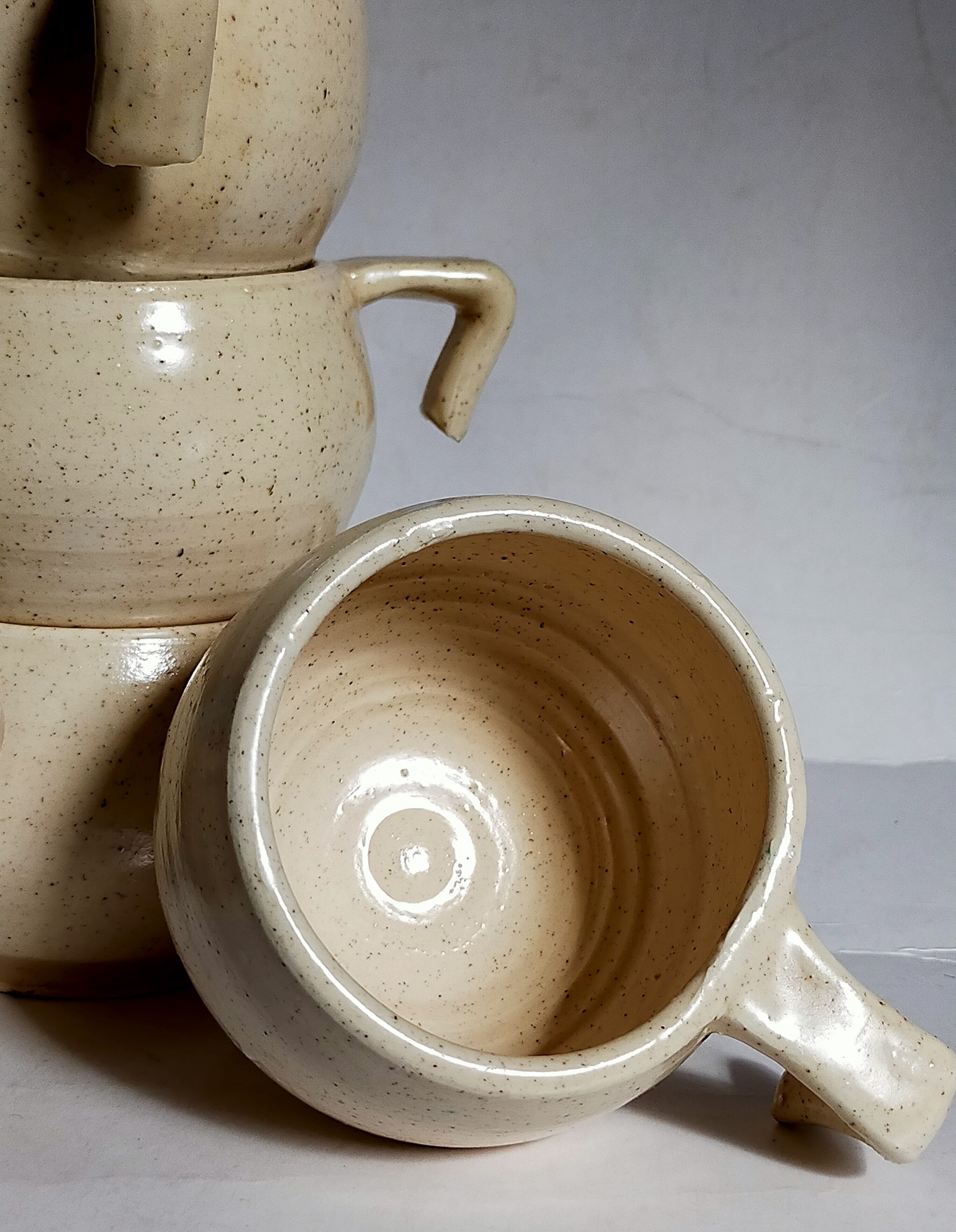 Six vintage potter's ceramic cups with vanilla enamel