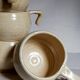 Six vintage potter's ceramic cups with vanilla enamel