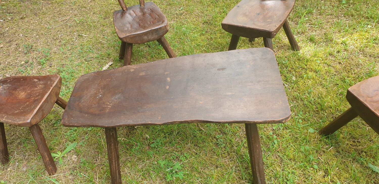 Four chairs and brutalist coffee table