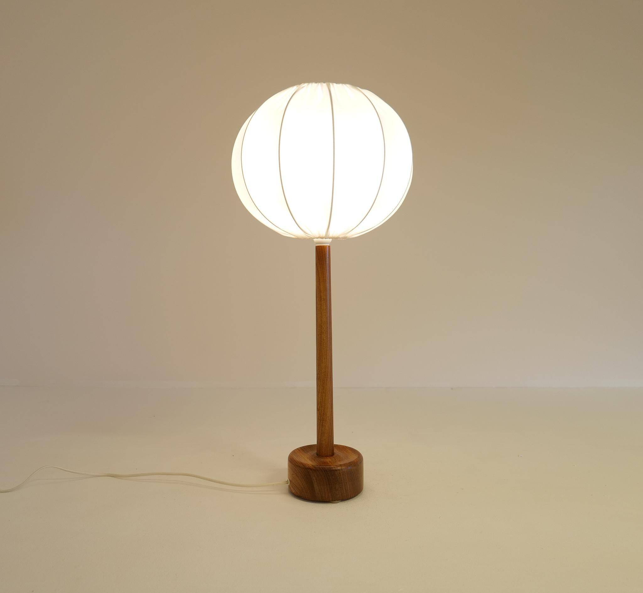 Mid-century solid teak table lamp from the 1960s Sweden.