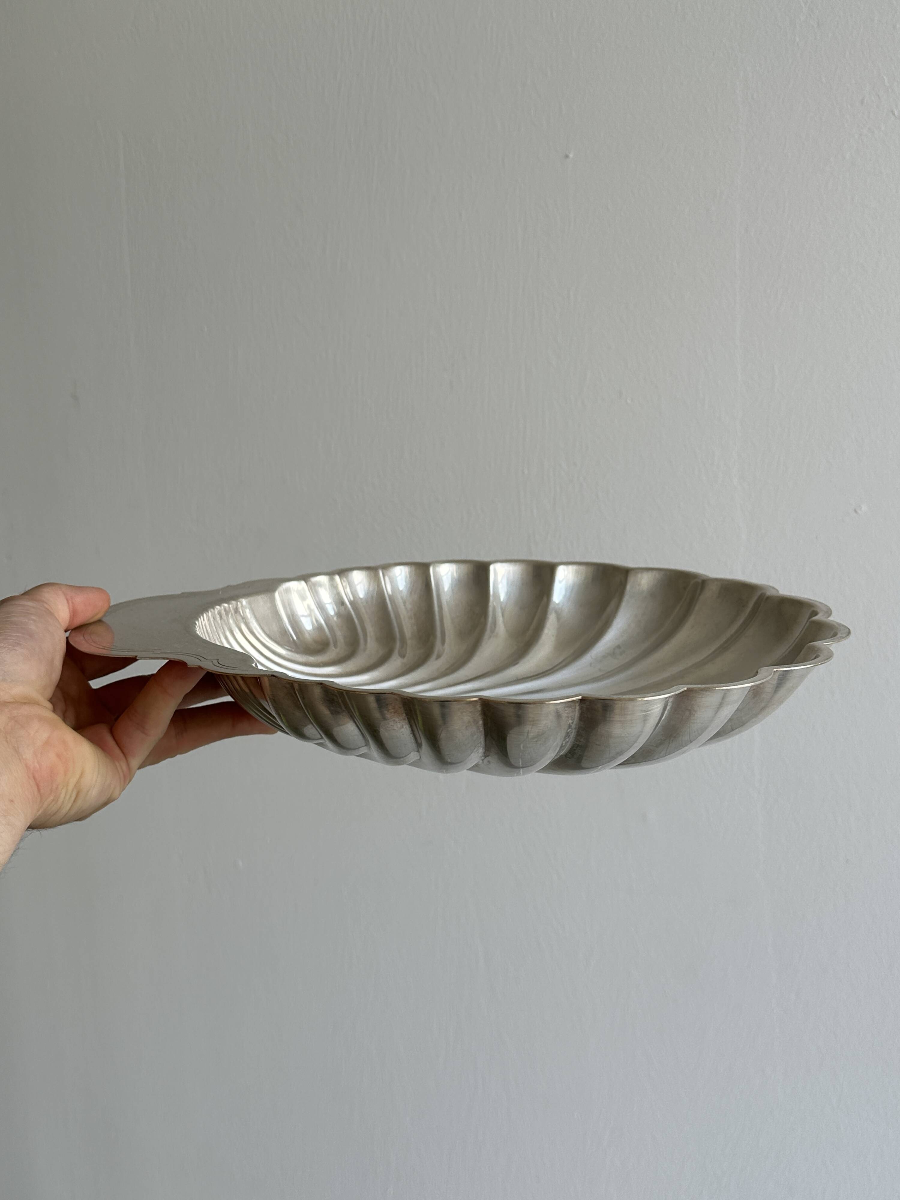 large silver-plated metal shell-shaped dish