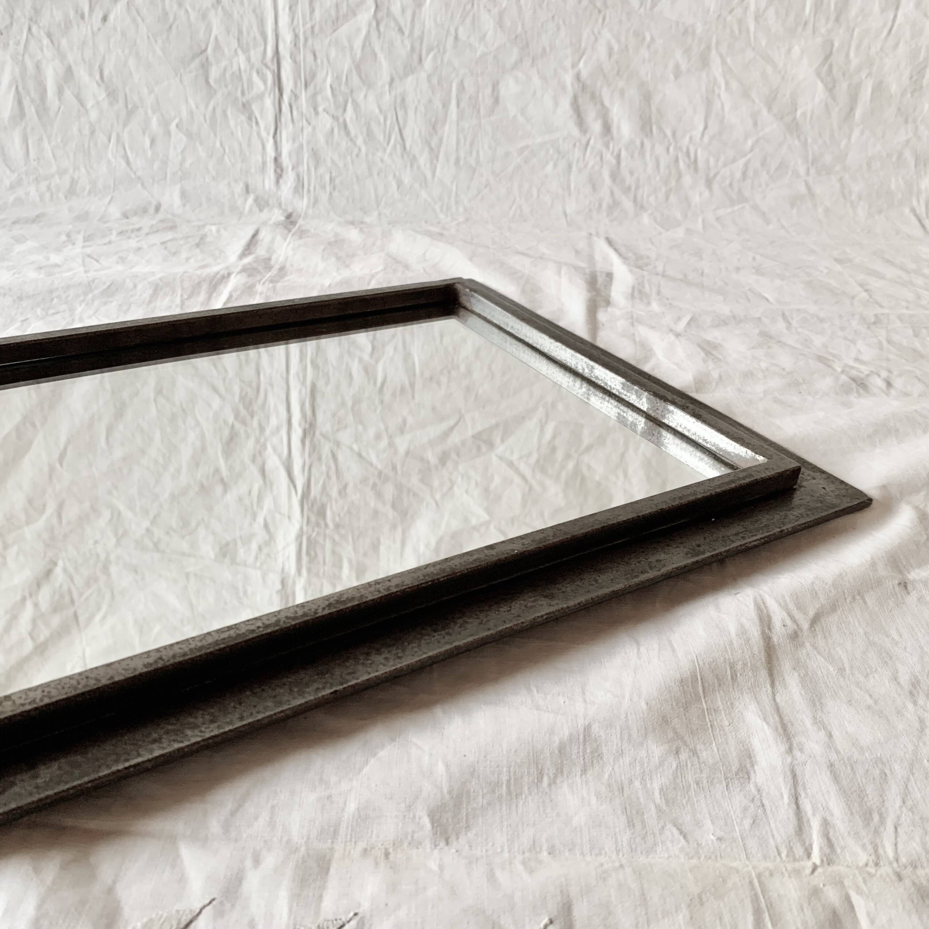 Vintage wall mirror in varnished steel decorated with a rose in relief