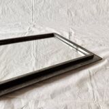 Vintage wall mirror in varnished steel decorated with a rose in relief