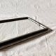 Vintage wall mirror in varnished steel decorated with a rose in relief
