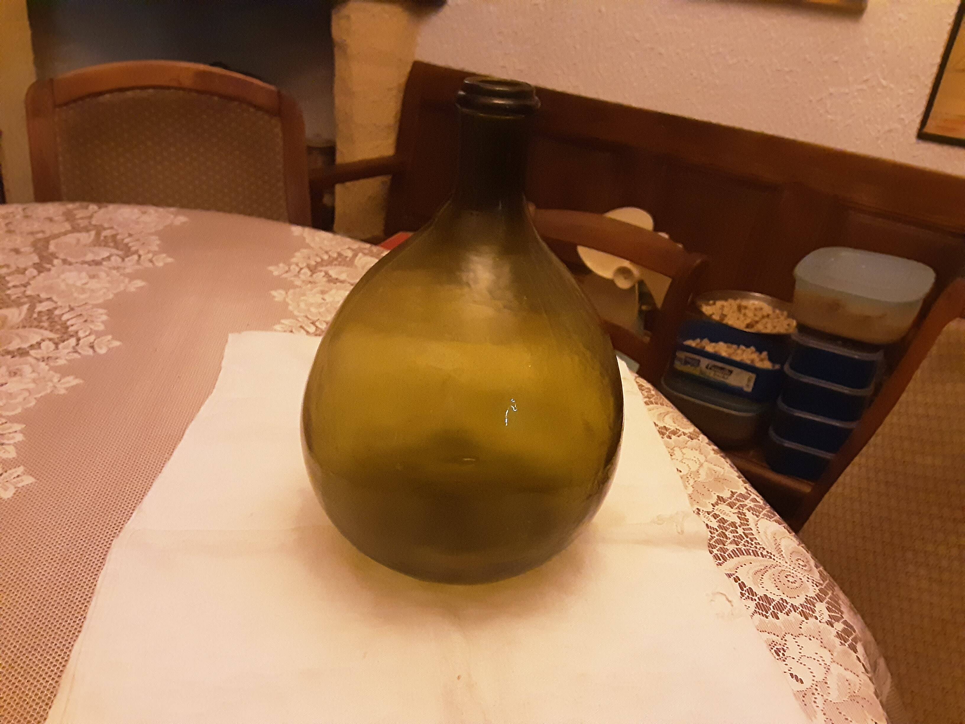 Old green glass demijeanne