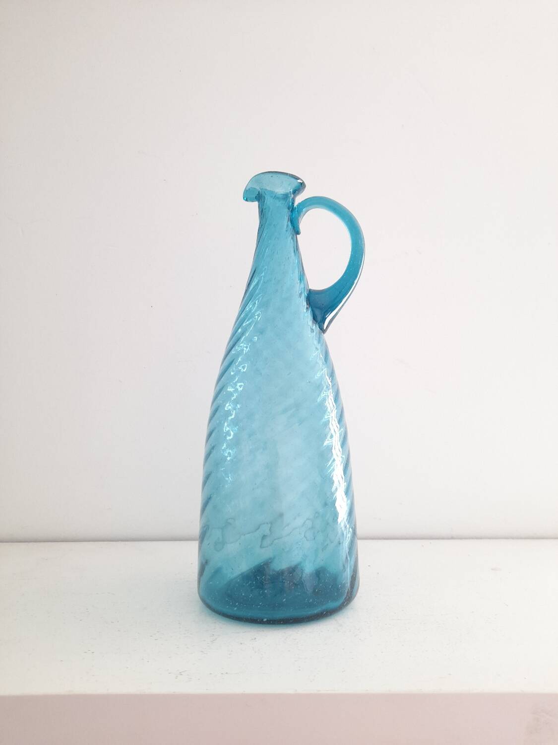 Tall twisted blue glass carafe