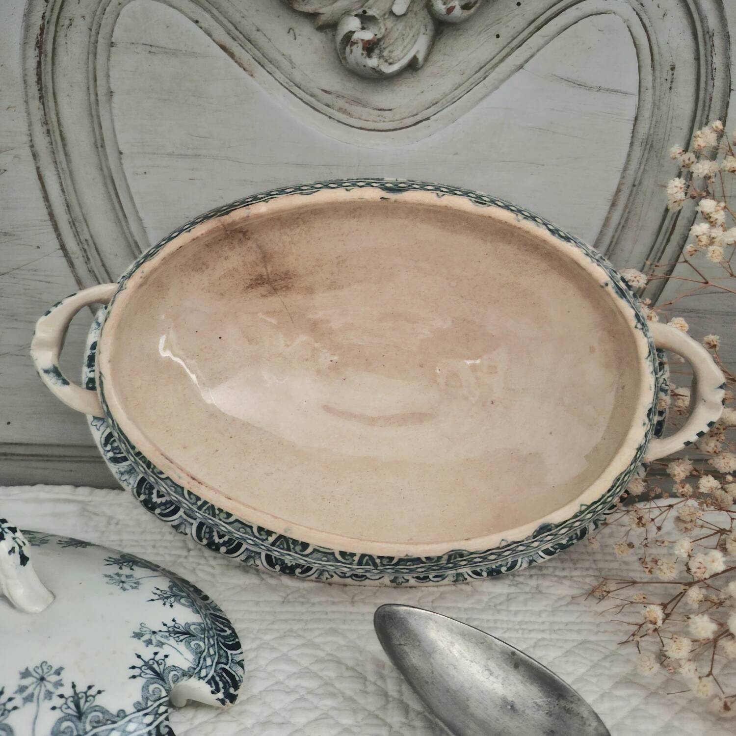 Antique iron earthenware sauceboat on a frame