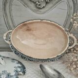 Old iron earthenware sauce boat on frame