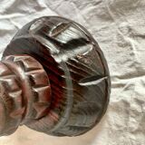 Old ashtray on carved wooden stand