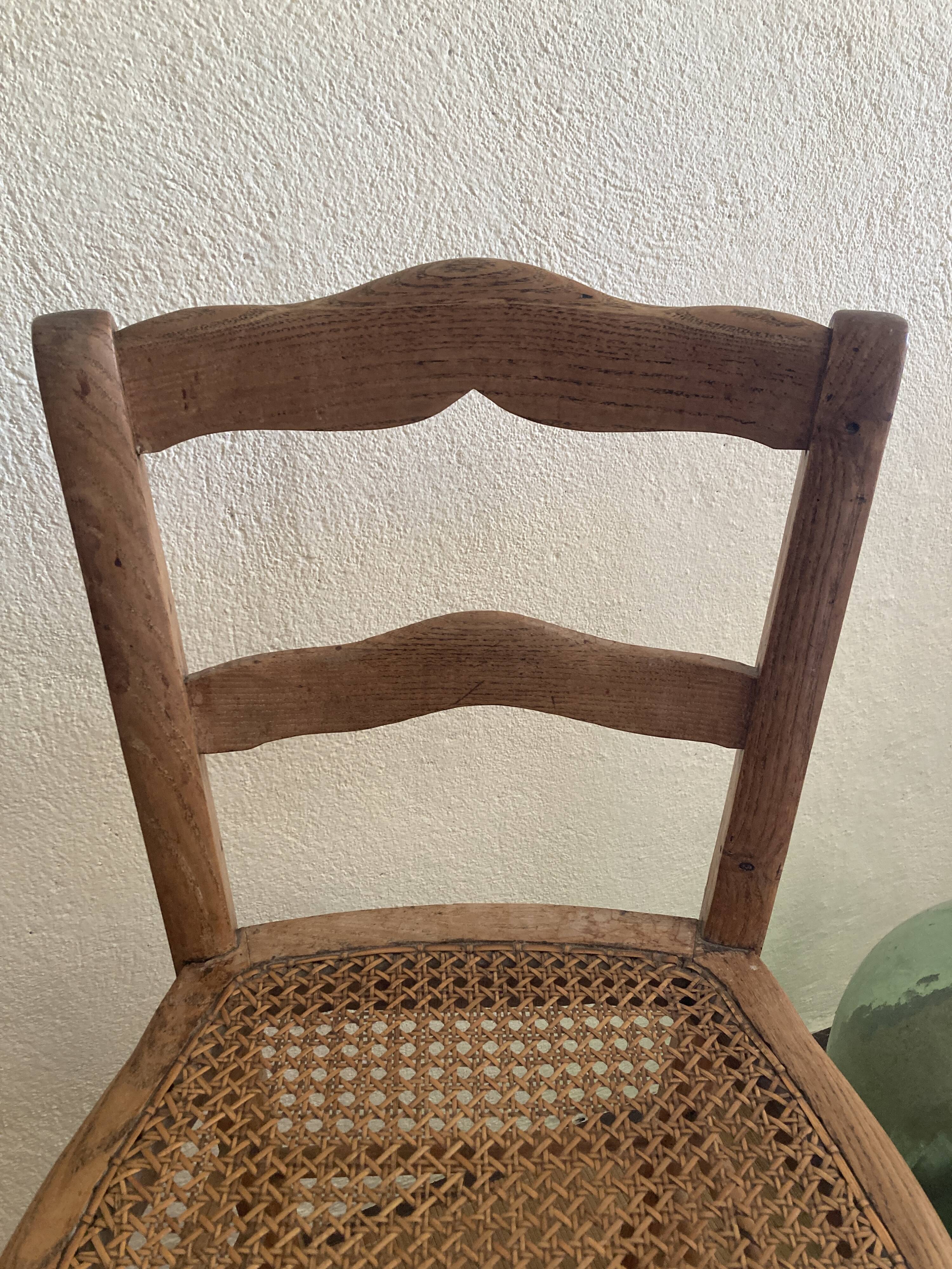 Set of two antique chairs with caning.