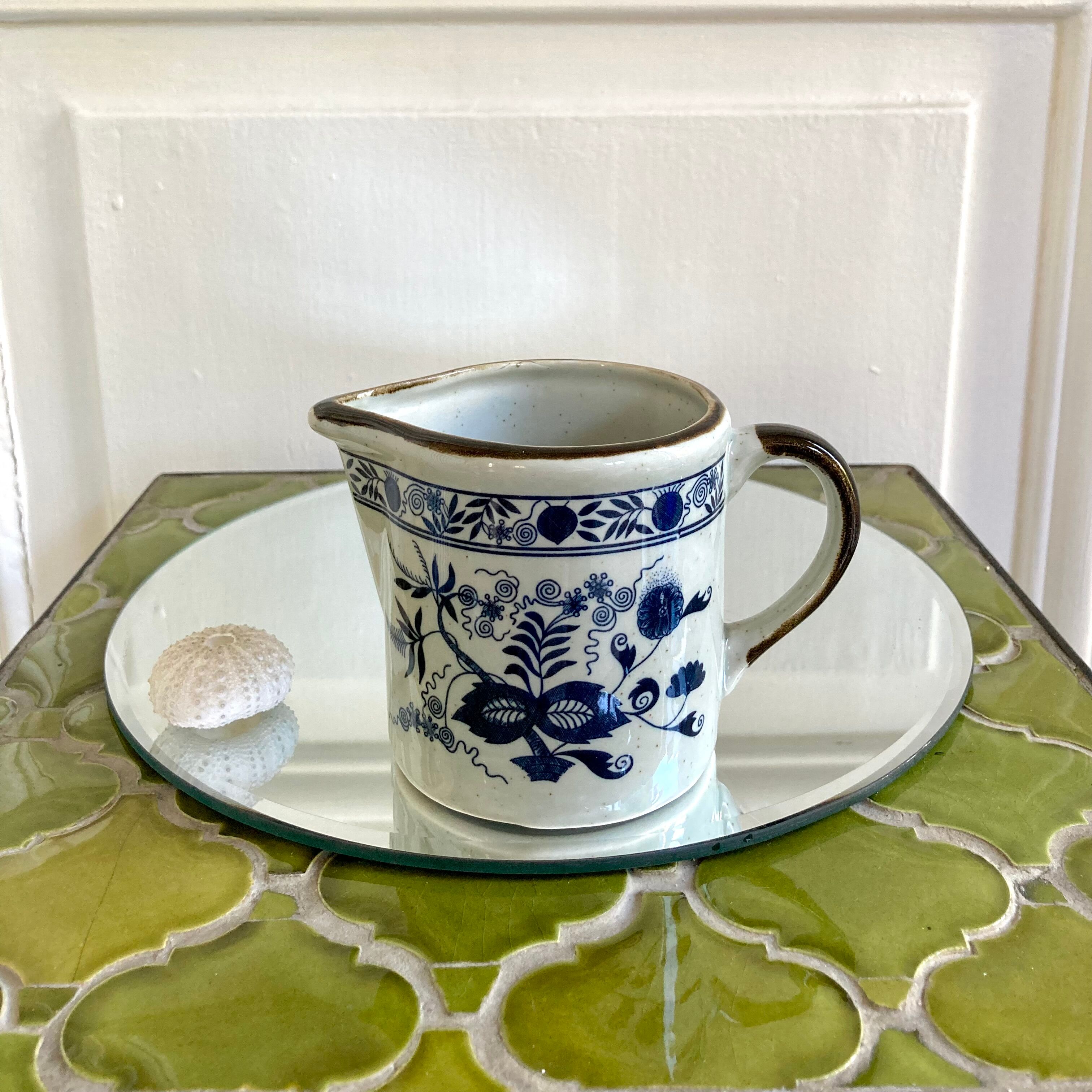 Stoneware milk jug with flower decoration